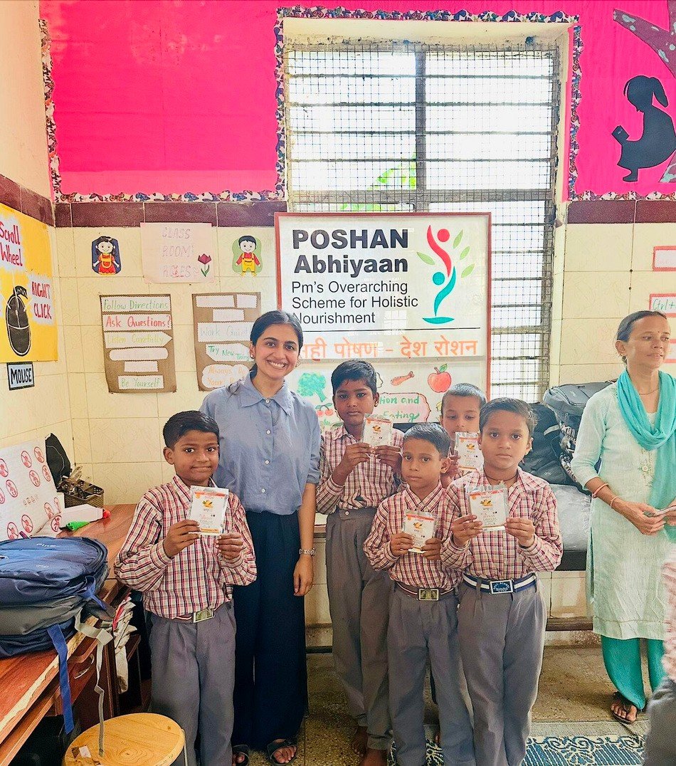 Mosachi program staff distributing the Natural Iron Fruit Bar under the Poshan Abhiyaan scheme